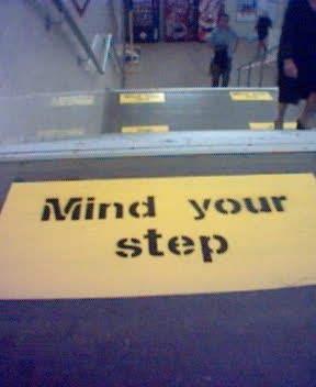 On the wide concrete stairs, they've painted “Mind Your Step” in big yellow letters at regular intervals.