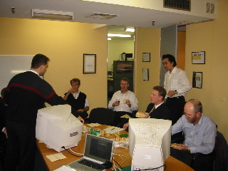 Various cow orkers sitting around a table...